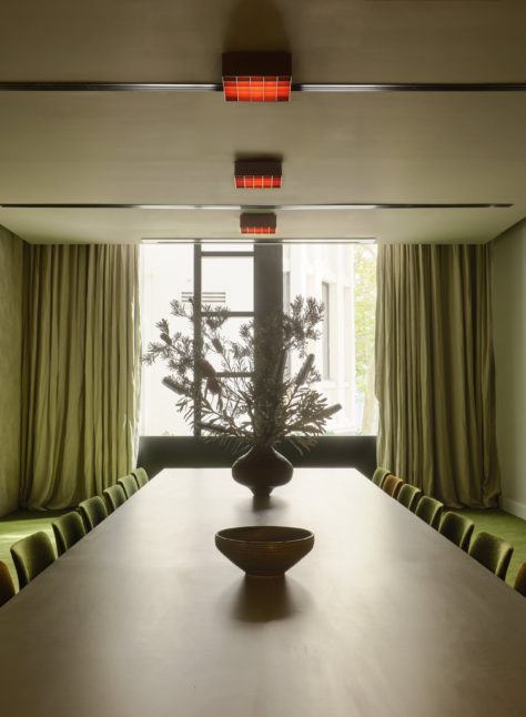 A cozy event space with a green theme is perfect smaller gatherings and meet ups