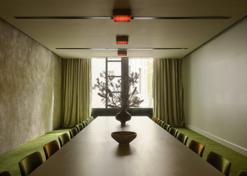 A cozy event space with a green theme is perfect smaller gatherings and meet ups